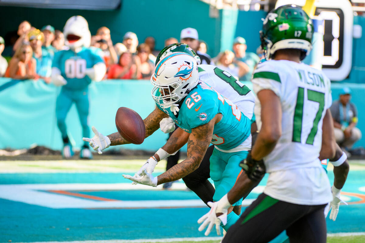 Miami Dolphins cornerback Xavien Howard (25) deflects the ball from New York Jets wide receiver ...