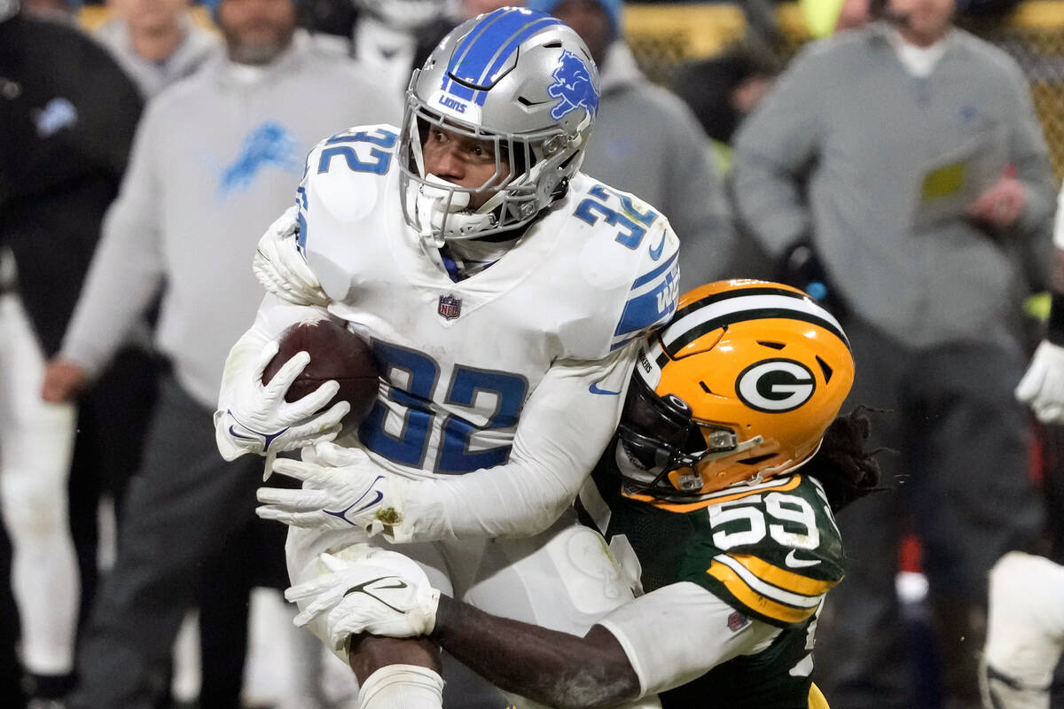 Detroit Lions running back D'Andre Swift (32) is stopped by Green Bay Packers linebacker De'Von ...