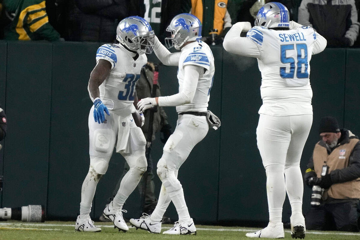 Detroit Lions running back Jamaal Williams (30) is congratulated by quarterback Jared Goff afte ...