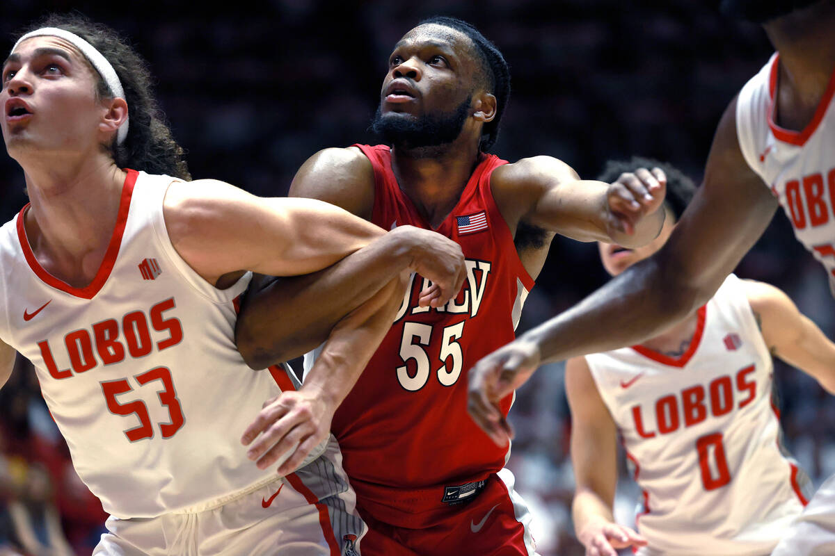 UNLV's EJ Harkless, center, and New Mexico's Josiah Allick, wait for a rebound during the secon ...
