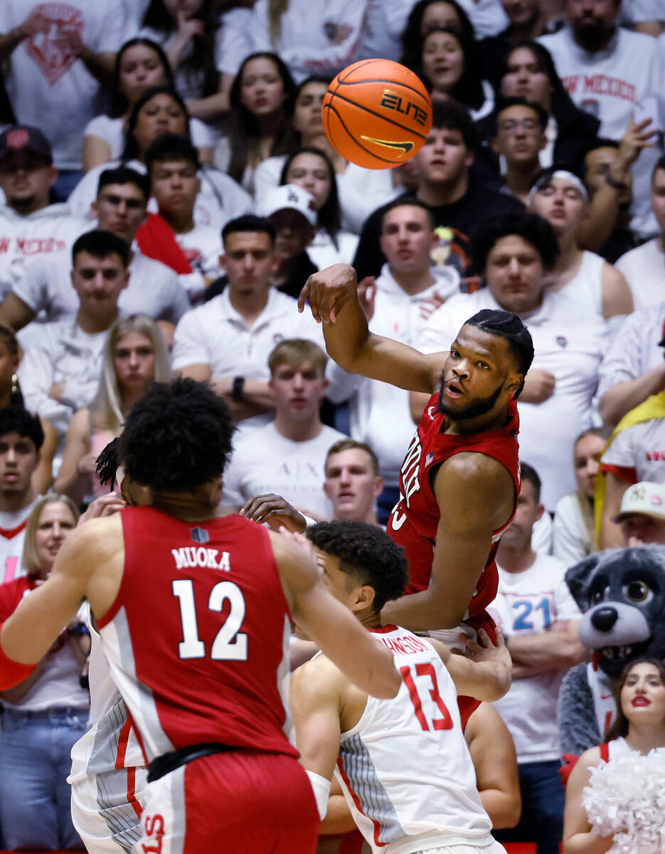 UNLV guard EJ Harkless passes the ball to David Muoka over New Mexico's Javonte Johnson during ...
