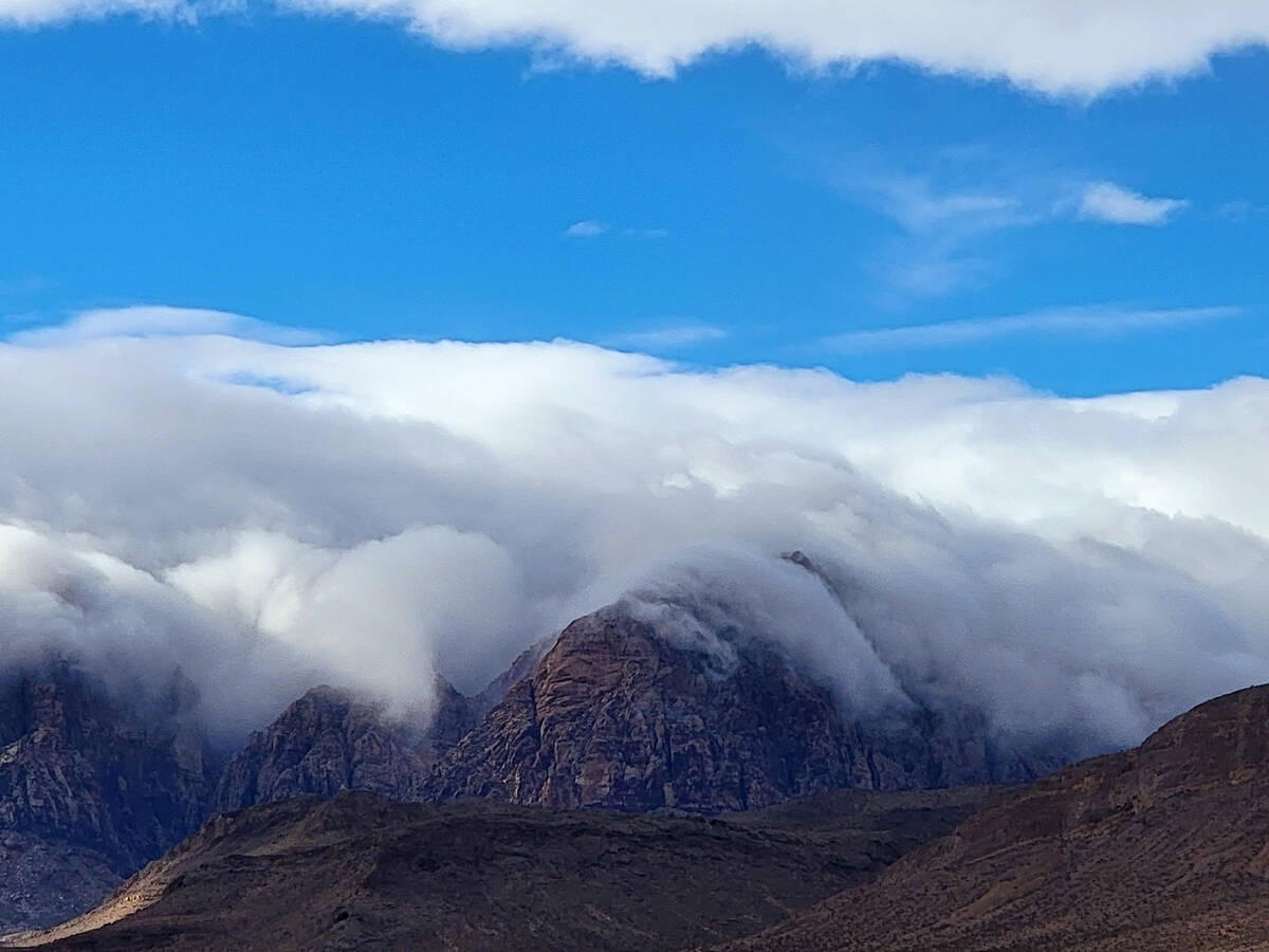 Clouds cascading over Red Rock’s east-facing escarpment on Jan. 1, 2023. (Natalie Burt/S ...