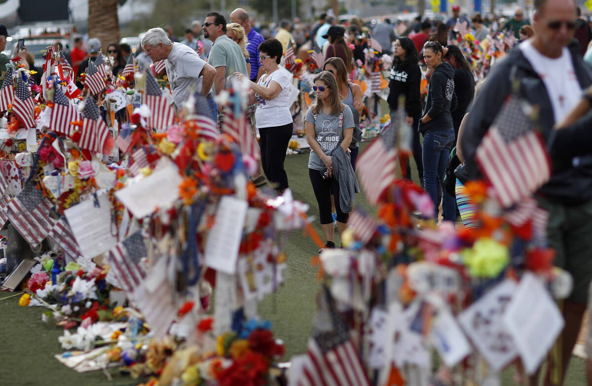 People visit a makeshift memorial honoring the victims of the Oct. 1 mass shooting on Nov. 12, ...