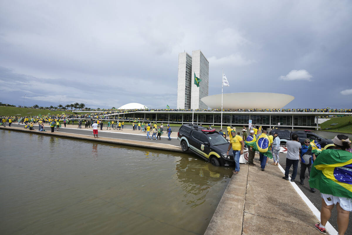 Protesters, supporters of Brazil's former President Jair Bolsonaro, storm the the National Cong ...