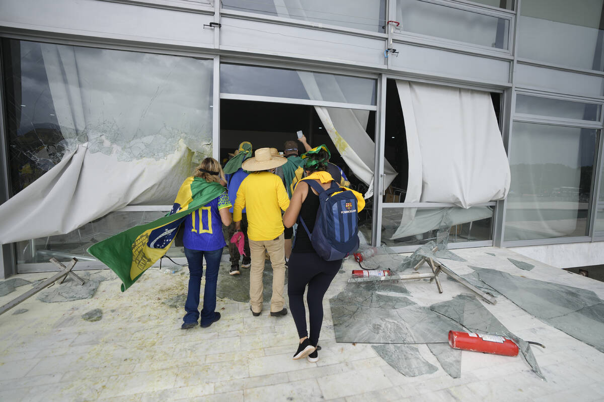 Protesters, supporters of Brazil's former President Jair Bolsonaro, storm the Planalto Palace i ...