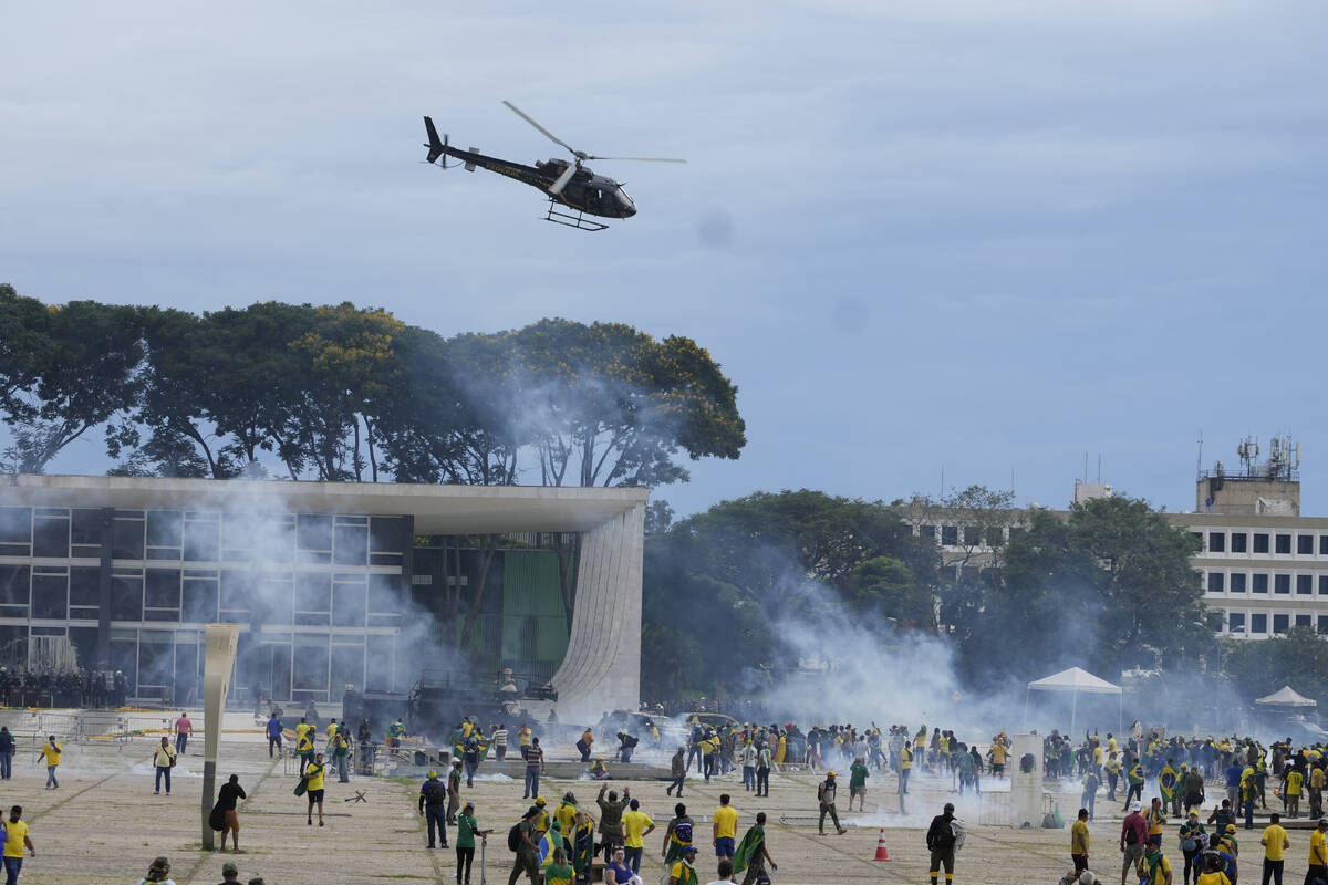 Protesters, supporters of Brazil's former President Jair Bolsonaro, clash with police as they s ...