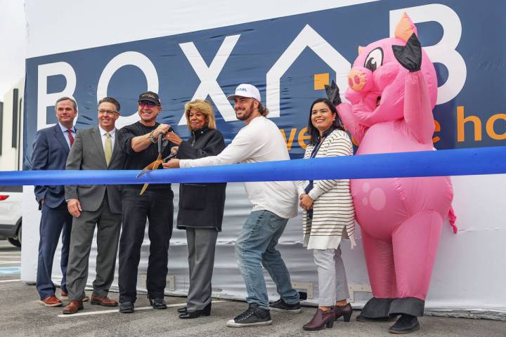 Paulo Tiramani, CEO of Boxabl, left, holds scissors with North Las Vegas Mayor Pamela Goynes-Br ...