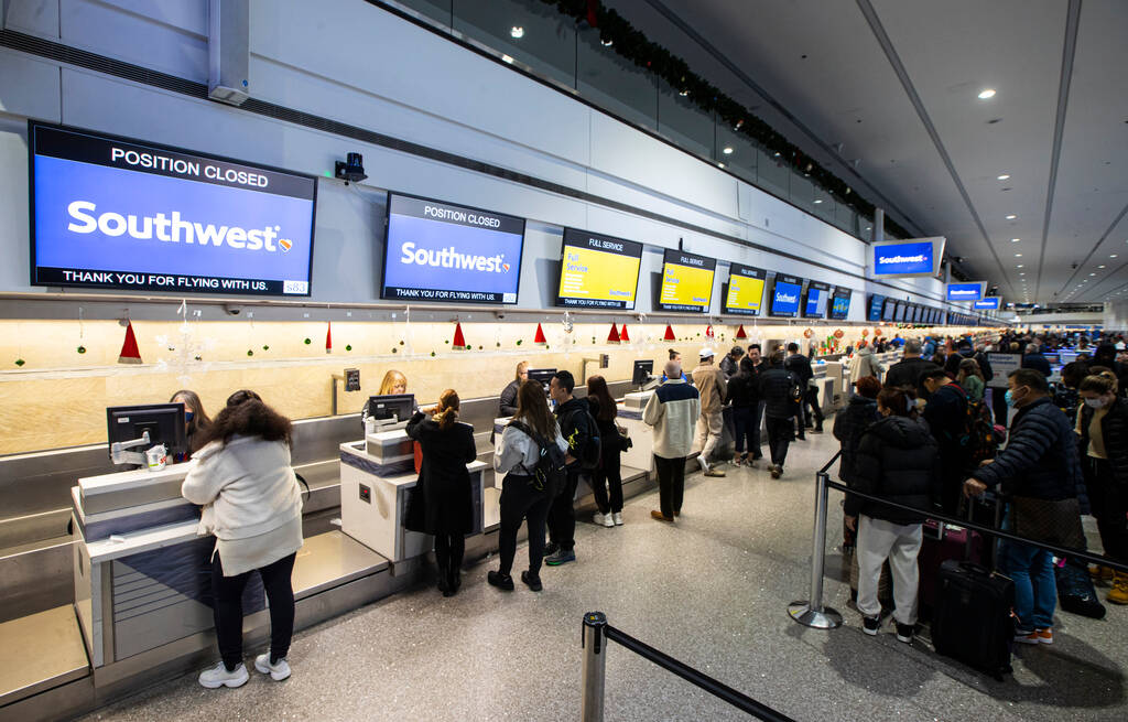 Passengers check in at Southwest Airlines at Harry Reid International Airport on Thursday, Dec. ...