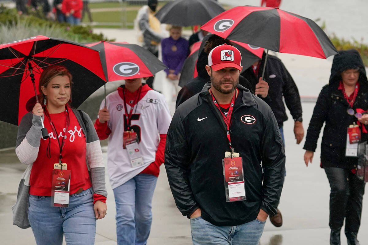 Georgia fans walk to SoFi Stadium in the rain before the national championship NCAA College Foo ...