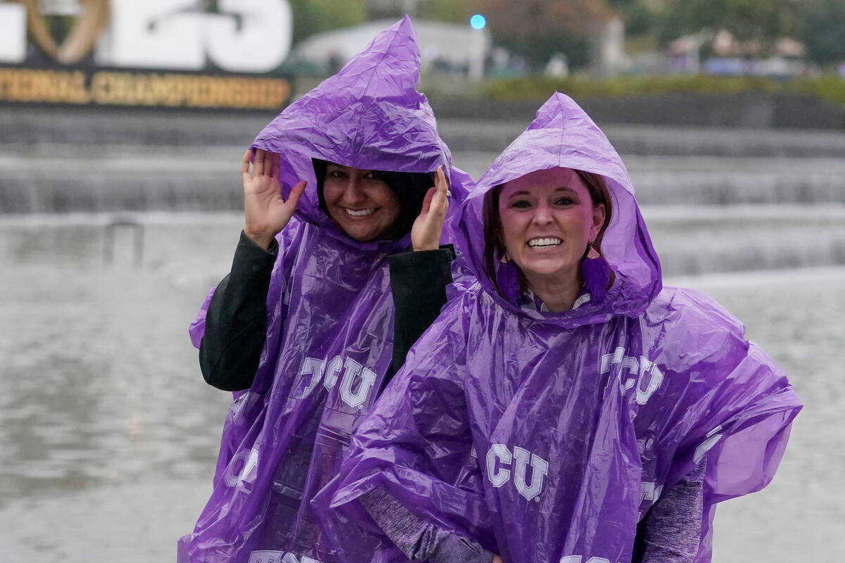TCU fans walk to SoFi Stadium in the rain before the national championship NCAA College Footbal ...