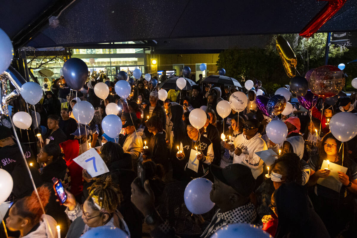 Friends and family of Ashari Hughes, 16, hold candles during a celebration of her life at Cente ...