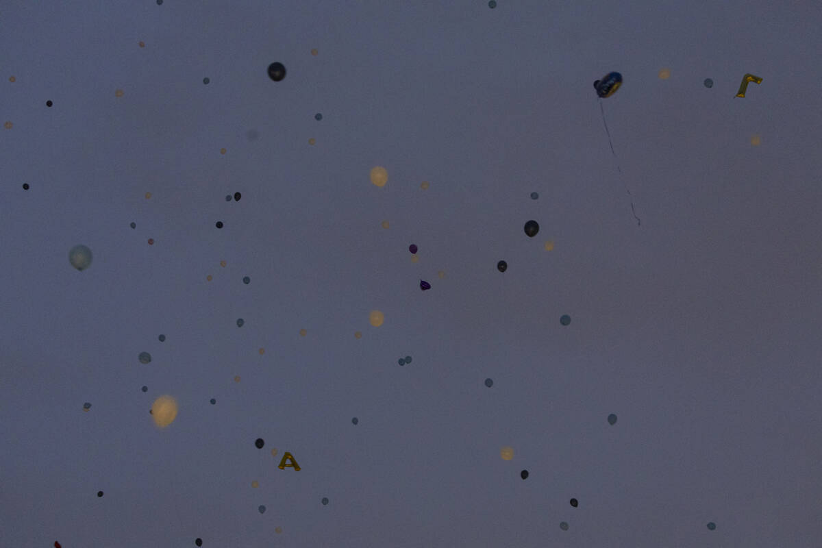 Balloons are released into the sky during a celebration of life in memory of Ashari Hughes, 16, ...