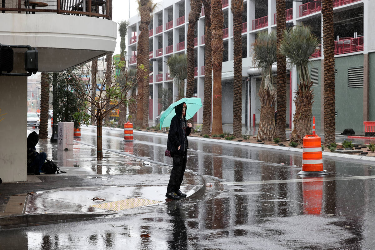 A pedestrian waits to cross the street at Las Vegas Boulevard and Fremont Street in Las Vegas T ...