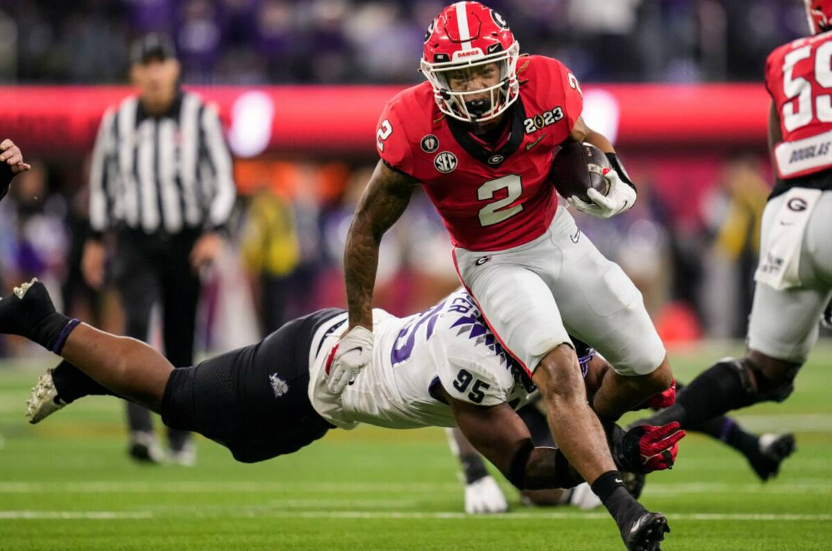 Georgia running back Kendall Milton (2) runs past TCU defensive lineman Terrell Cooper (95) dur ...