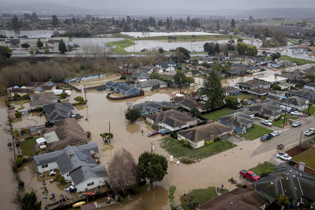 Flooding from huge amounts of rain are seen in a neighborhood off of Holohan Road near Watsonvi ...