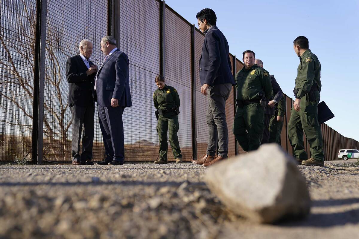 President Joe Biden talks with Oscar Leeser, Mayor of the City of El Paso, Texas, as they stand ...