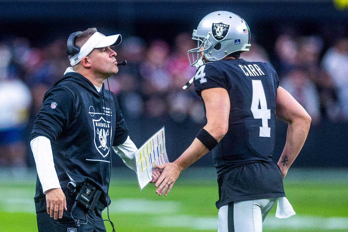 Raiders Head Coach Josh McDaniels congratulates quarterback Derek Carr (4) after a score during ...