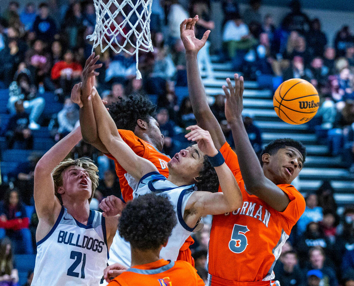 Bishop Gorman guard Jaxon Richardson (5) looks to a loose ball after colliding with Centennial ...