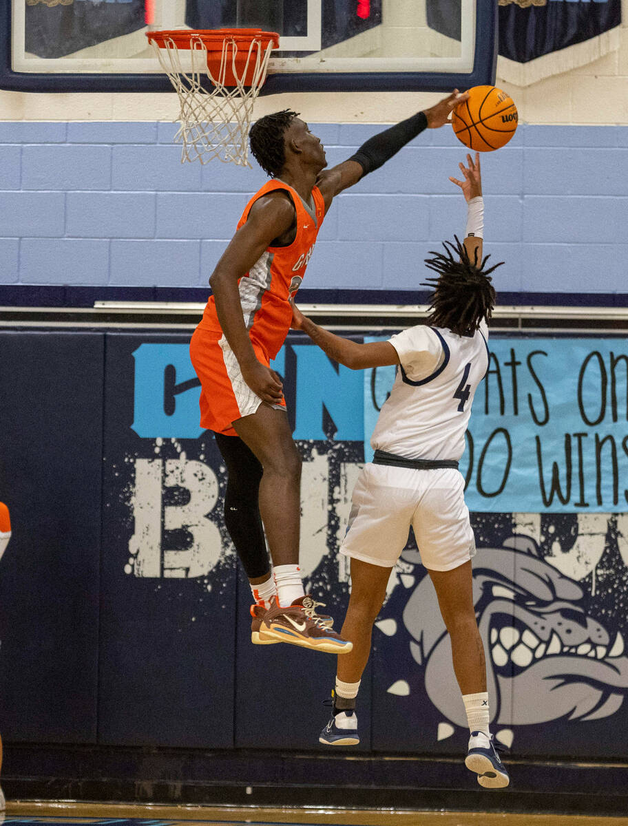 Bishop Gorman forward Christopher Nwuli (23) rejects a shot attempt by Centennial guard Levi Sw ...