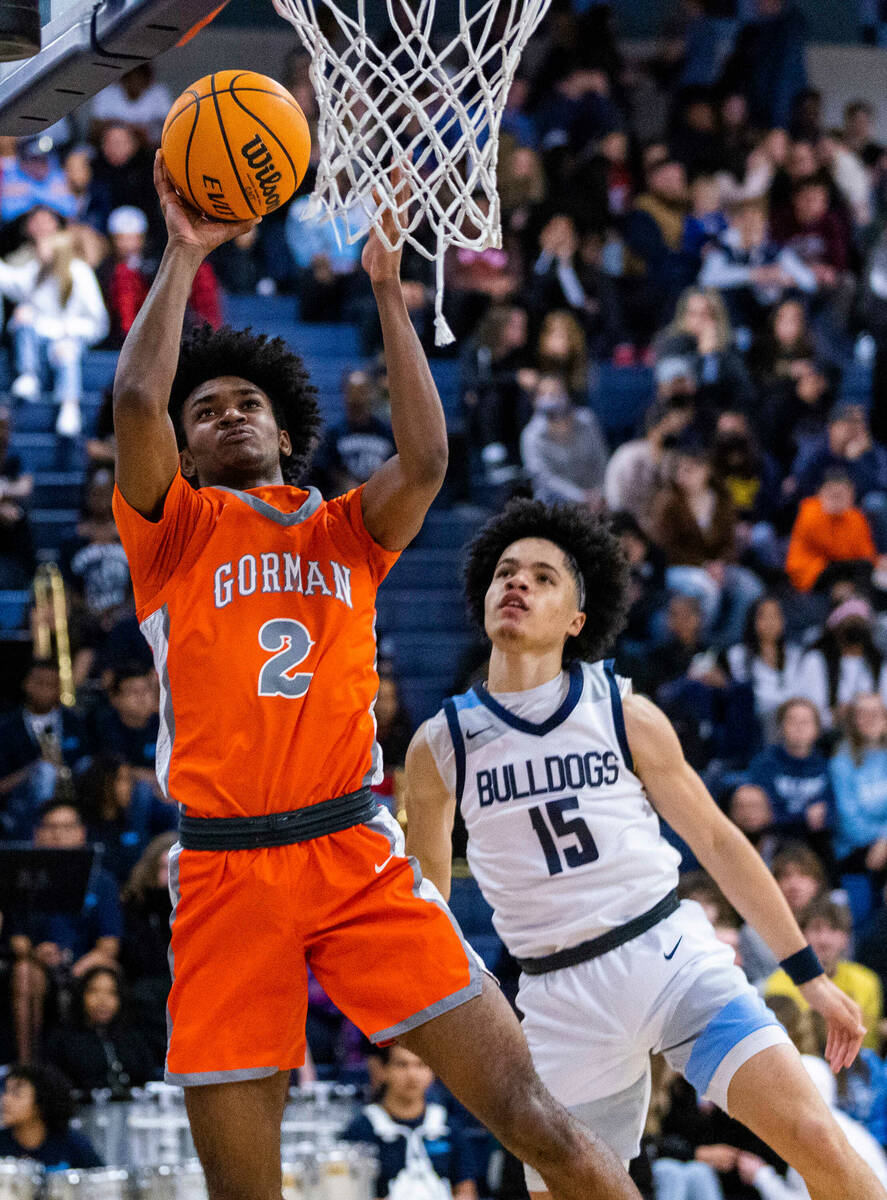 Bishop Gorman forward Keenan Bey (2) gets inside of Centennial guard Elijah Burney (44) during ...