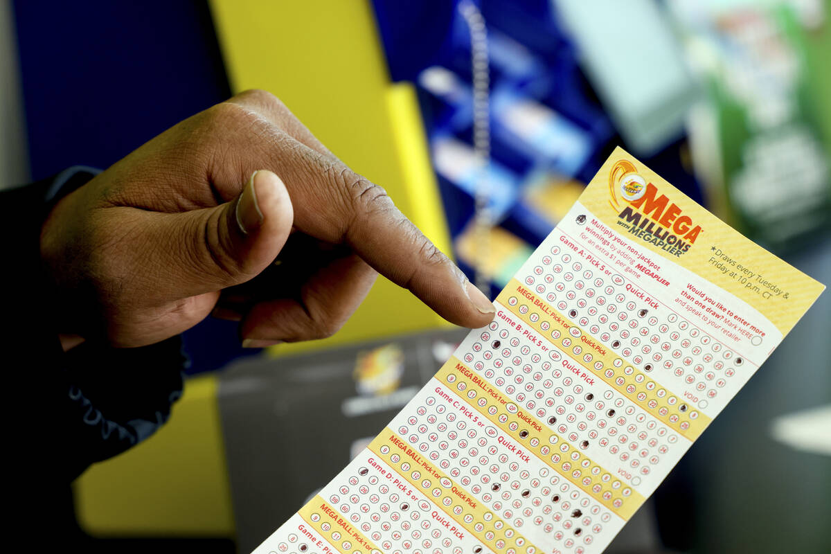 A Mega Millions lottery slip is displayed at Lucky Mart in Chicago on Tuesday, Jan. 10, 2023. A ...