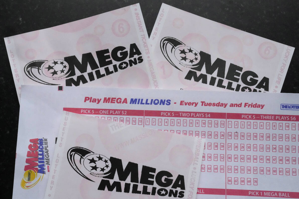 FILE - Mega Millions lottery tickets and a wager slip are displayed, Friday, Jan. 6, 2023, in D ...