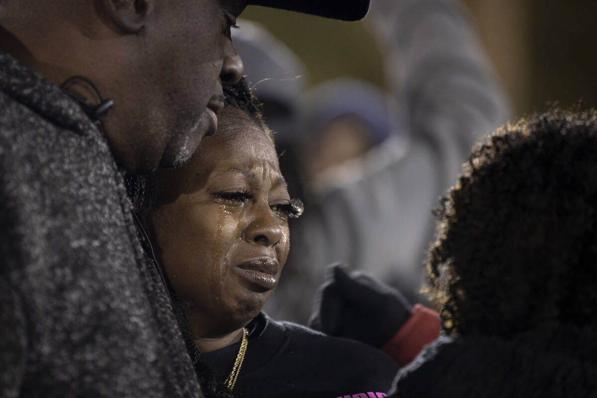 Ashari Hughes’ grandfather Sammie Toles, left, embraces her mother Twayne Hughes during ...