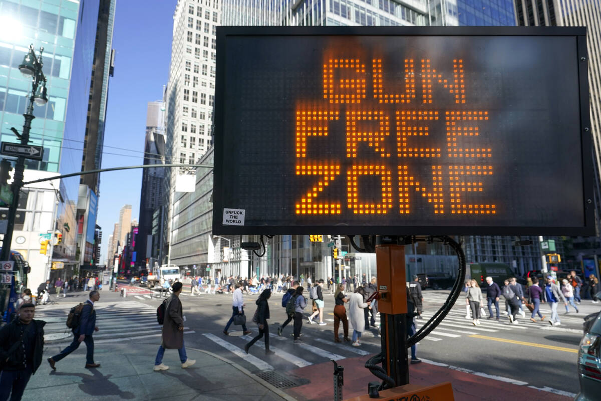 FILE - A traffic sign on the corner of 42nd Street and 6th Avenue announces Times Square as a g ...