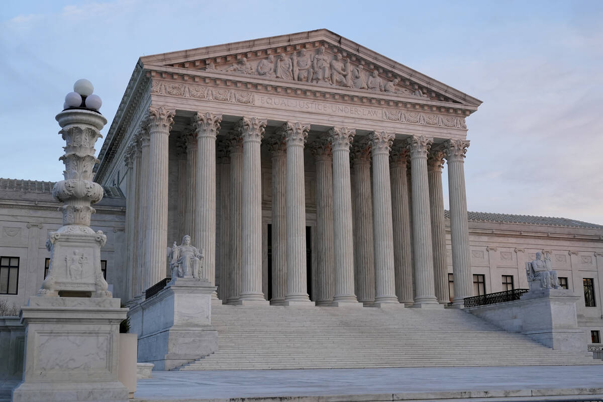 The setting sun illuminates the Supreme Court building on Capitol Hill in Washington, Tuesday, ...