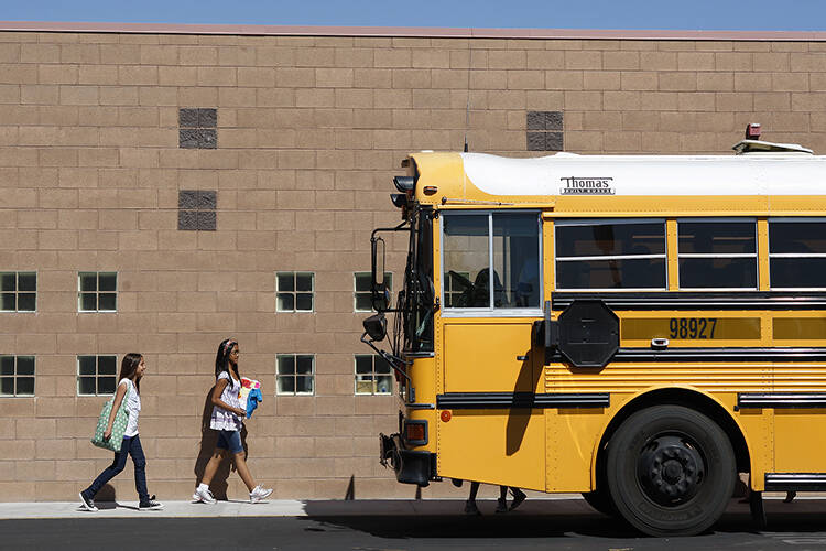FILE - A school bus idles in the parking lot of the Mabel Hoggard Elementary School on Tuesday, ...