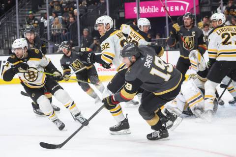Golden Knights right wing Reilly Smith (19) follows after the puck next to Boston Bruins left w ...