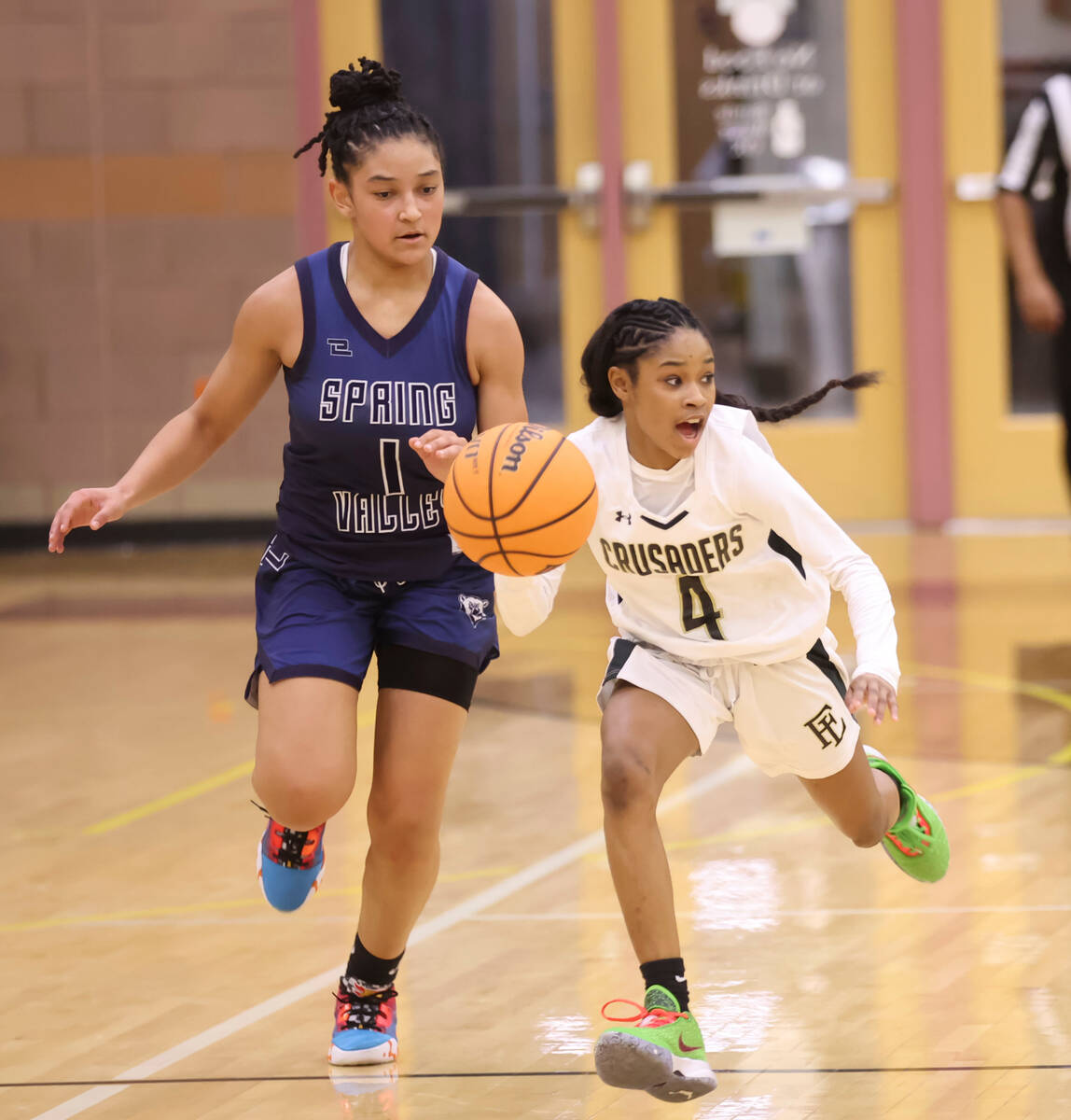 Faith Lutheran's Tamiah Harrison (4) brings the ball up court against Spring Valley's Mia Ervin ...