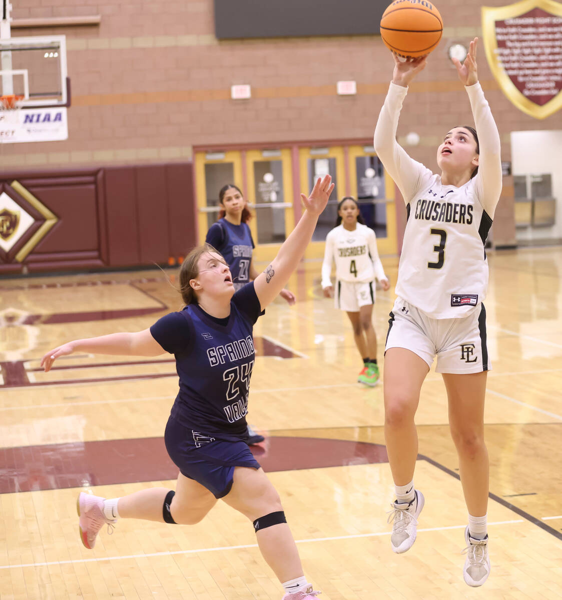 Faith Lutheran's Gabby Libonati (3) shoots under pressure from Spring Valley's Delaney Bartlett ...