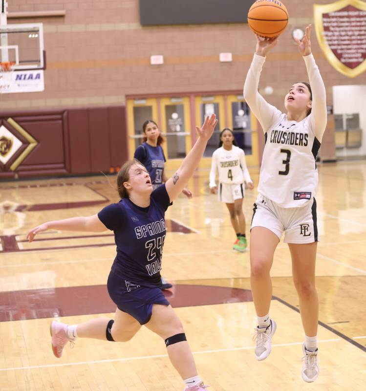 Faith Lutheran's Gabby Libonati (3) shoots under pressure from Spring Valley's Delaney Bartlett ...