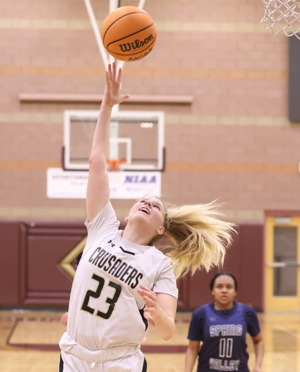 Faith Lutheran's Raina Forgue (23) lays up the ball against Spring Valley during the second hal ...