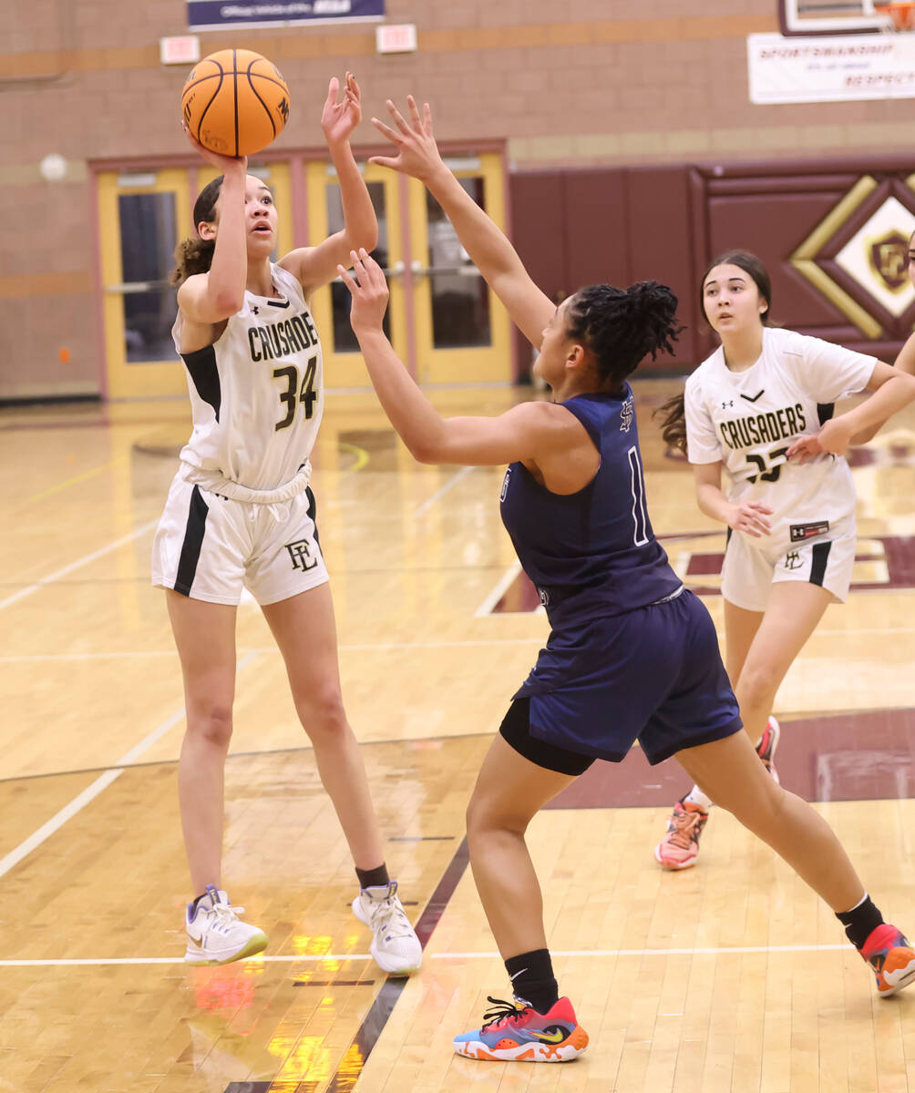 Faith Lutheran's Leah Mitchell (34) shoots over Spring Valley's Mia Ervin (1) during the second ...