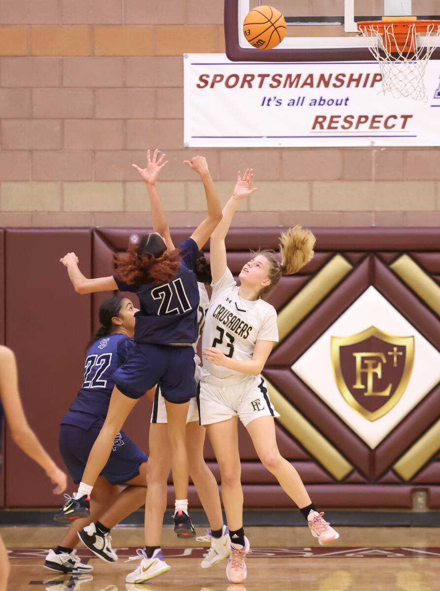 Spring Valley's Charolette De Lisle (21) shoots over Faith Lutheran's Raina Forgue (23) during ...