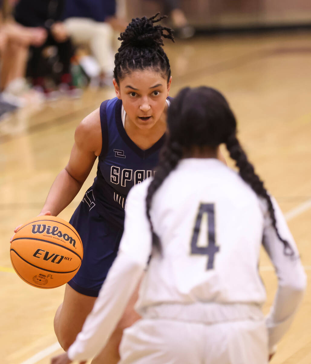 Spring Valley's guard Mia Ervin (1) drives the ball against Faith Lutheran's Tamiah Harrison (4 ...
