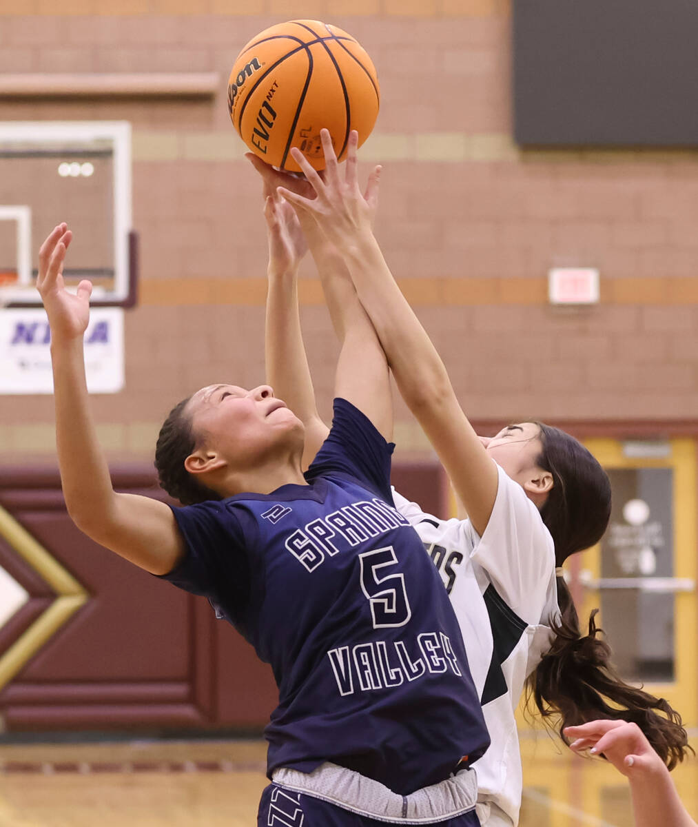 Spring Valley's Gia McFadden (5) and Faith Lutheran's Emma Herpin (33) fight for a rebound duri ...