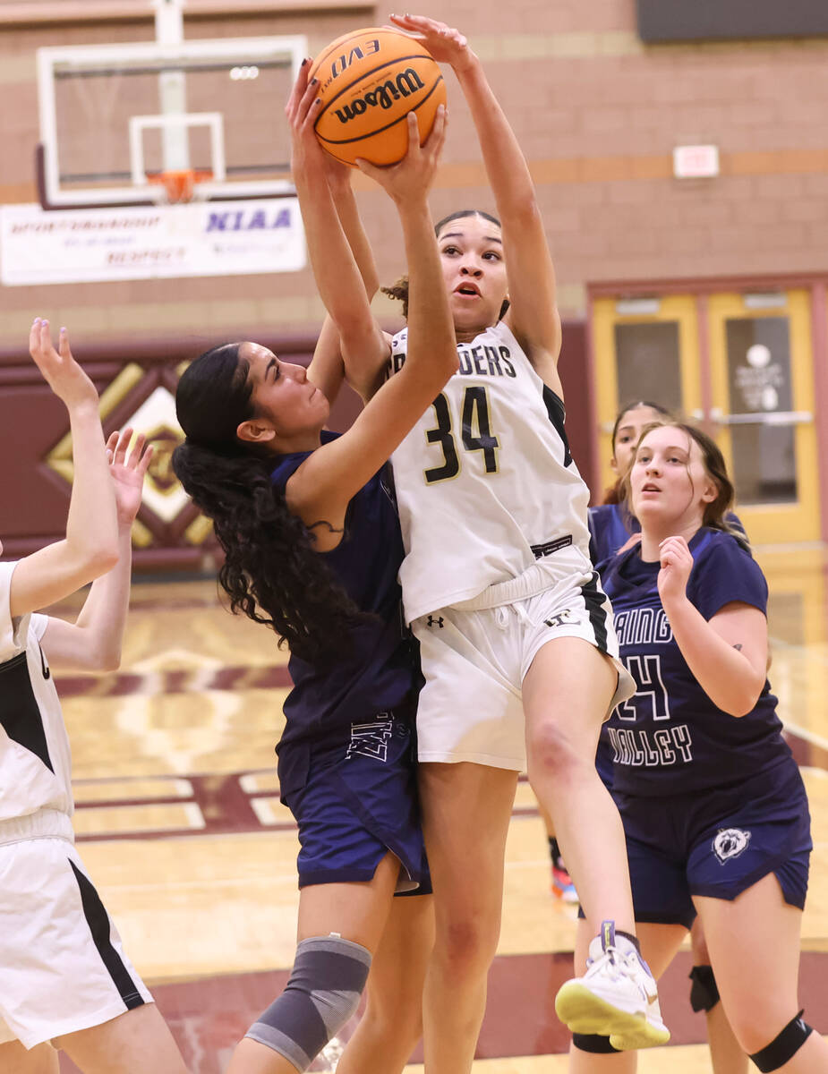 Spring Valley's Melanie Ortiz (10) and Faith Lutheran's Leah Mitchell (34) fight for a rebound ...