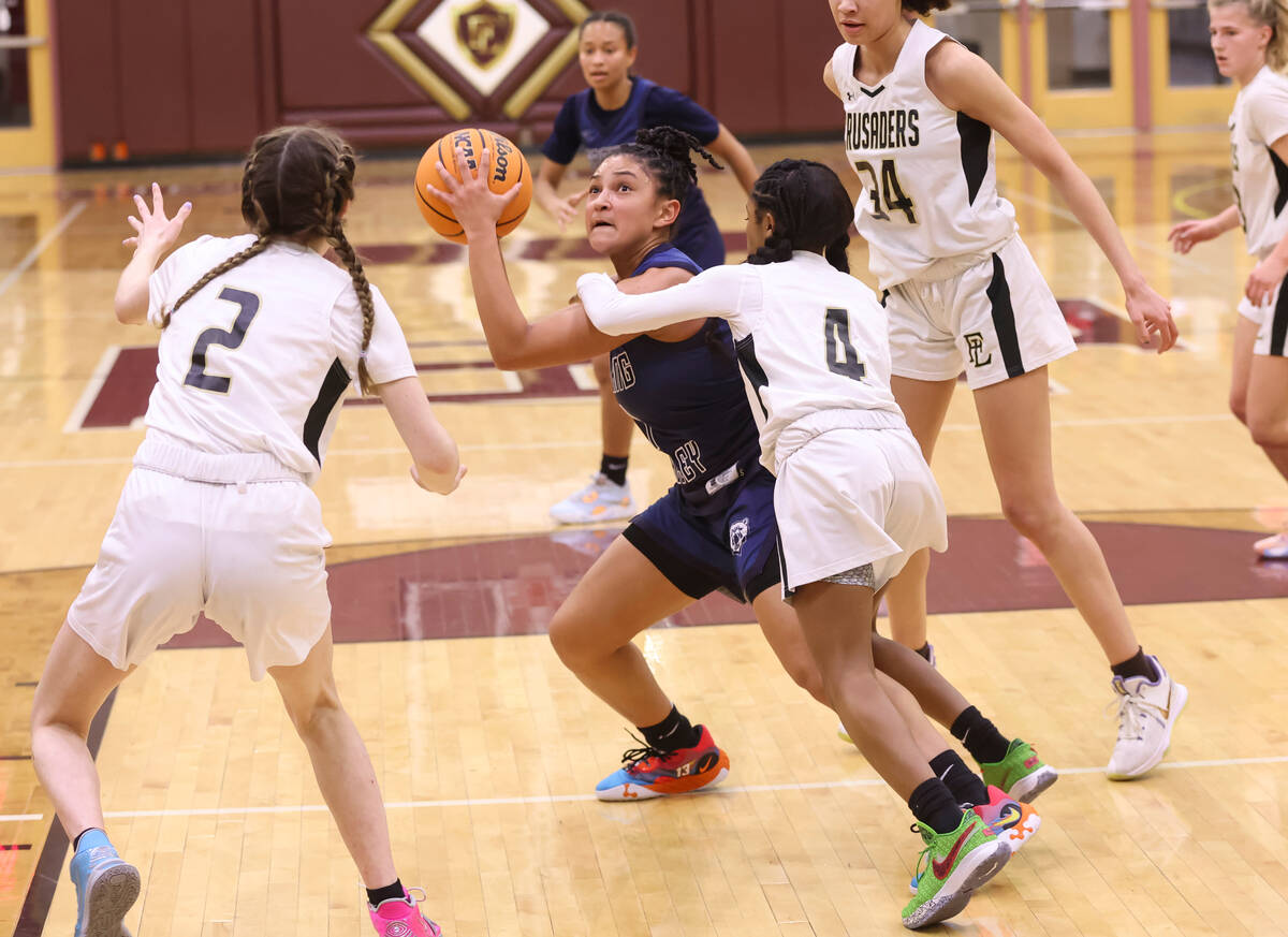 Spring Valley's Mia Ervin (1) looks to shoot under pressure from Faith Lutheran's Tamiah Harris ...