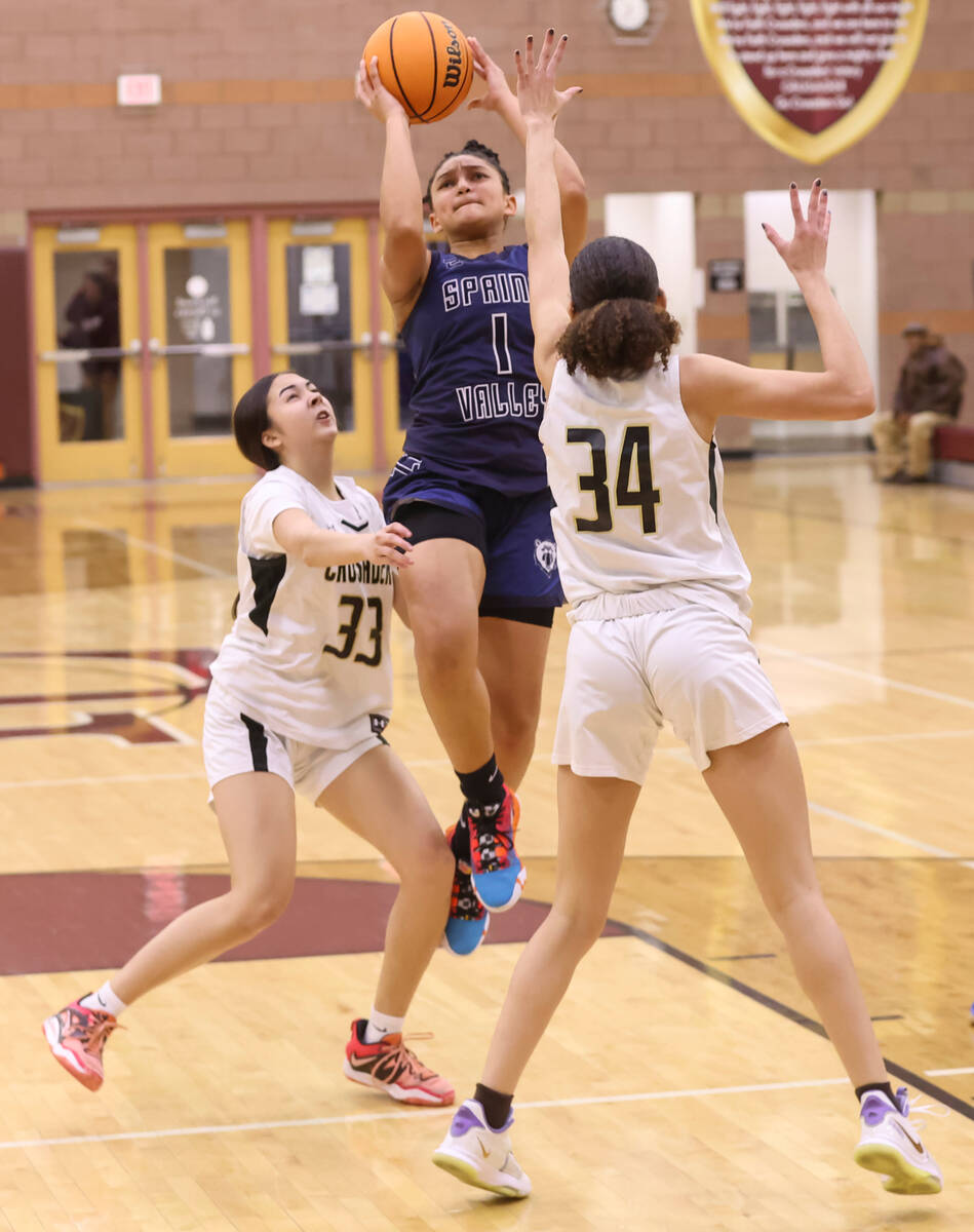 Spring Valley's Mia Ervin (1) shoots between Faith Lutheran's Emma Herpin (33) and Leah Mitchel ...