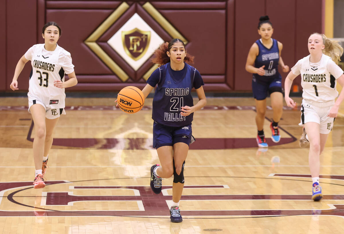 Spring Valley's Charolette De Lisle (21) brings the ball up court against Faith Lutheran during ...
