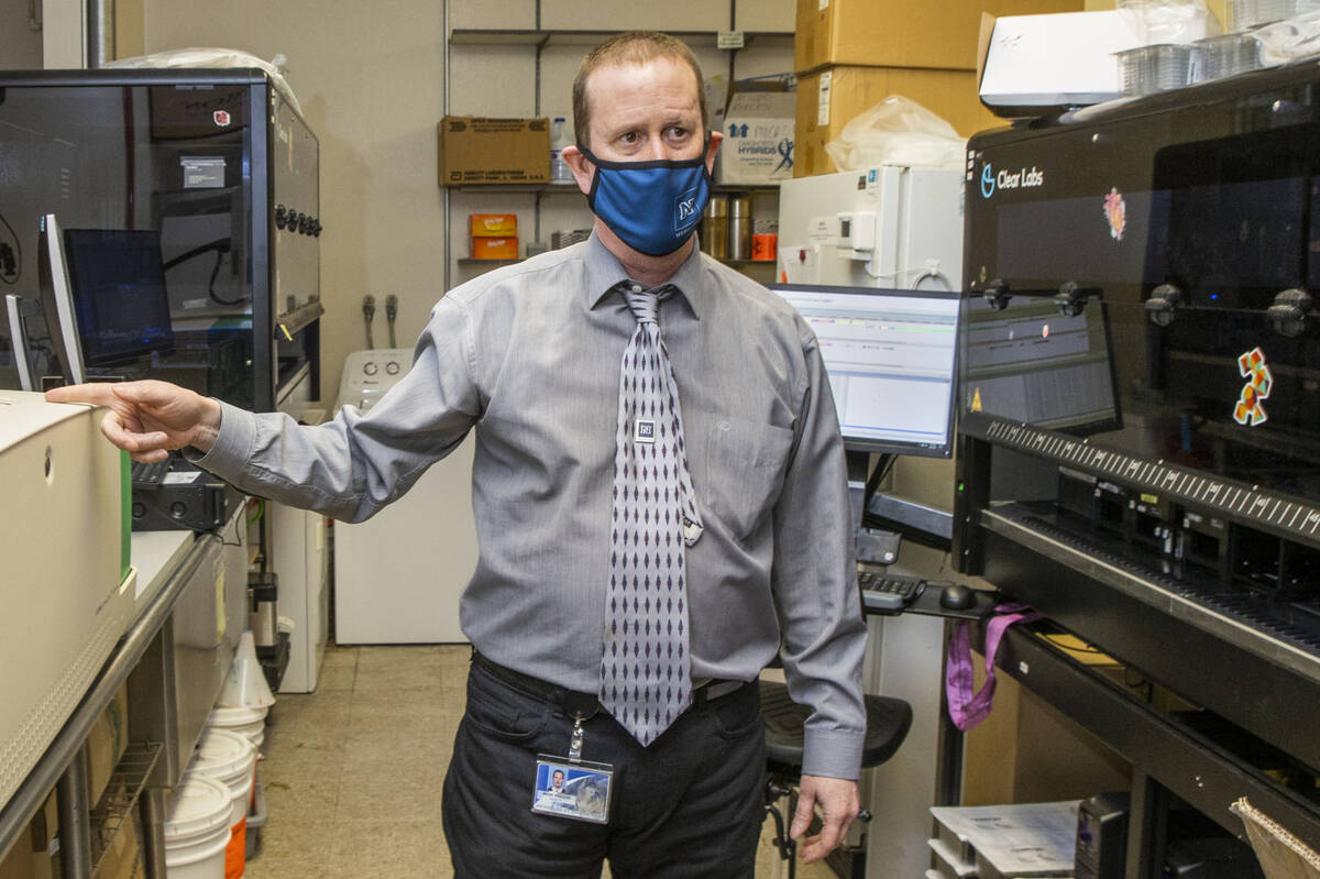 Dr. Mark Pandori, director of the Nevada State Public Health Lab, shows some of the technology ...