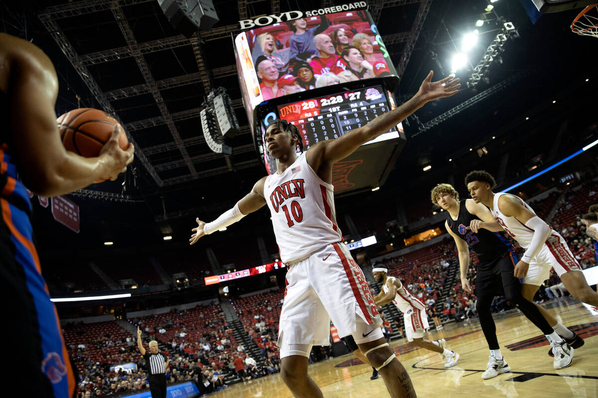 UNLV Rebels guard Keshon Gilbert (10) gets big to block the Boise State Broncos during the firs ...