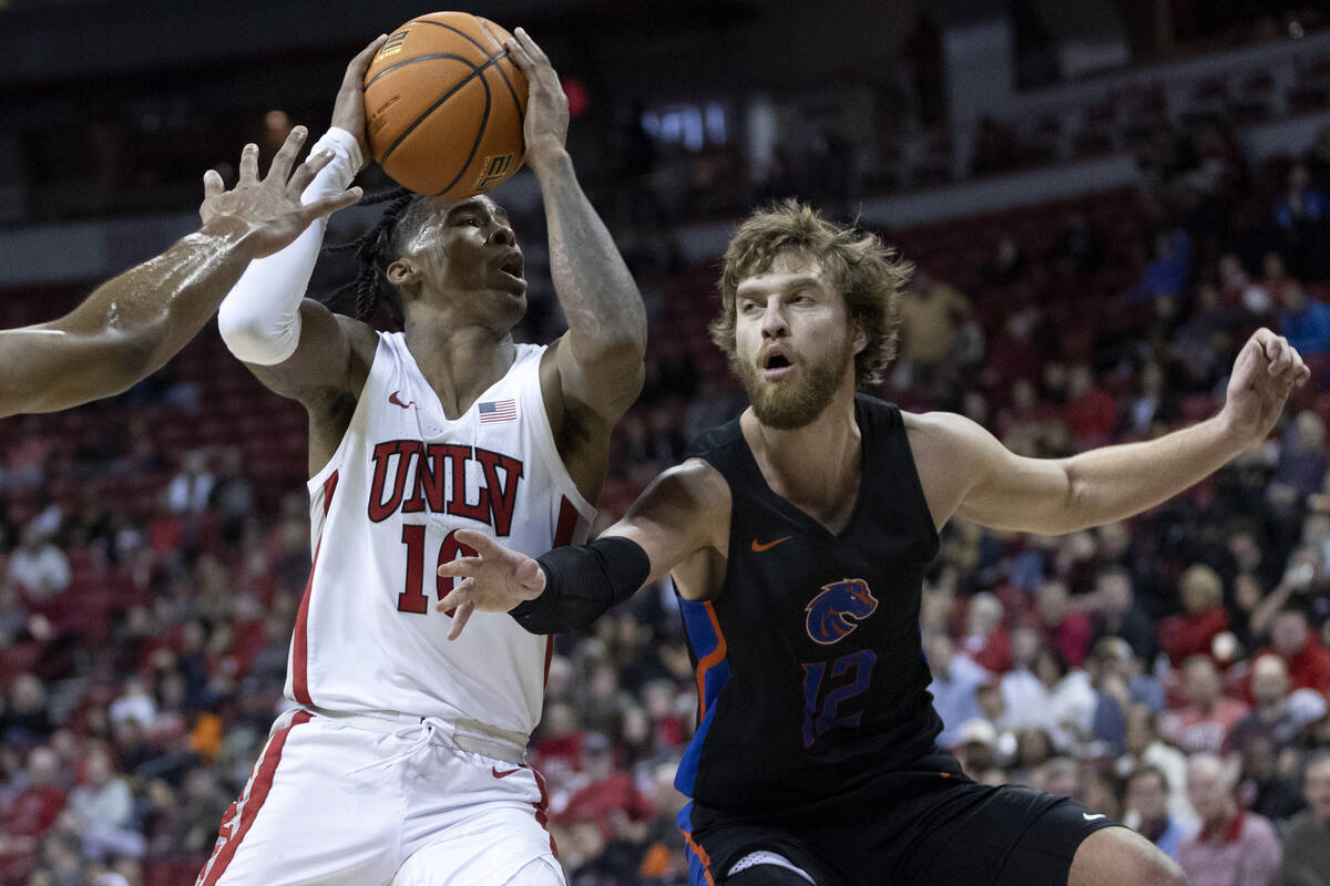 UNLV Rebels guard Keshon Gilbert (10) drives around Boise State Broncos guard Max Rice (12) dur ...
