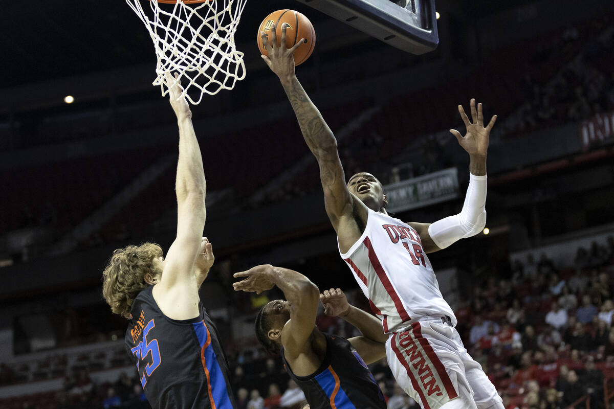 UNLV Rebels guard Luis Rodriguez (15) goes for a layup while Boise State Broncos center Lukas M ...