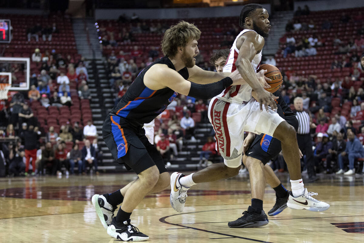 UNLV Rebels guard EJ Harkless (55) drives toward the hoop past Boise State Broncos guard Max Ri ...