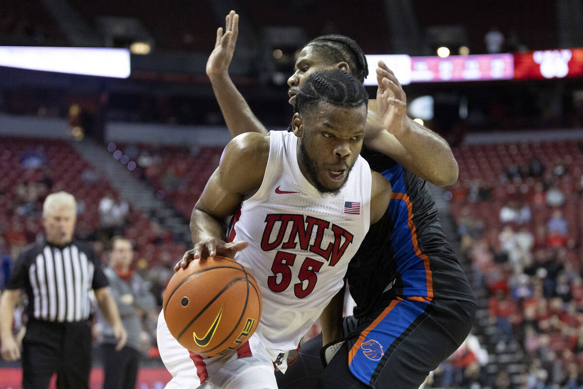 UNLV Rebels guard EJ Harkless (55) dribbles around Boise State Broncos guard Chibuzo Agbo (11) ...