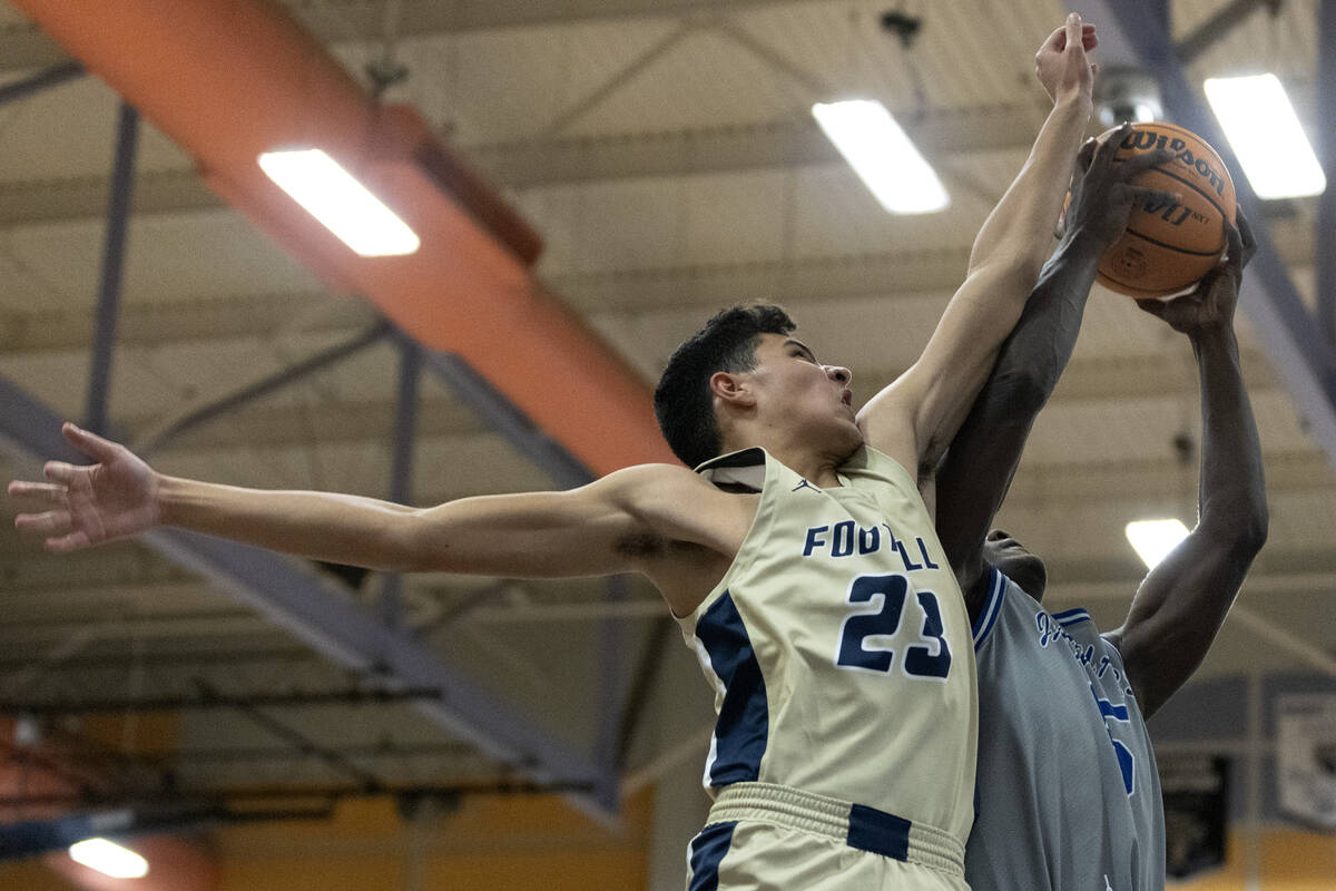 Foothill’s Shawn Salazar (23) attempts to block a shot by Desert Pines’ Greg Burr ...